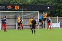 The Hadleigh keeper punches away, under pressure from Josh Youngs. Picture: TONY MILES