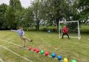 Duncan Baker, MP for North Norfolk, taking part in a head-to-head with Hindringham head Tom Snowdon at beat the goalie at Hindringham Primary School as the finale for her 60 events for 60 years