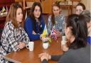 A new support hub for Ukrainian refugees has opened in Dereham Baptist Church. Some of the refugees gather to chat over tea and cake during the first event.