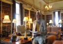 Sam Mortlock with a copy of his book inside The Long Library, Holkham Hall, in 2007