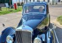 David Holmes (driving, left) takes Norman Rayner (right) for a drive in a Bentley car.