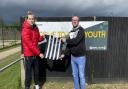 Todd Cantwell and Andrew Wright, vice-chair of Dereham Town Youth FC, with the kit donated from 4Sports