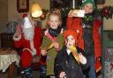 Happy children wave their golden tickets from Santa in ROARR! Dinosaur Adventure's Santa's Gotto. Picture: Danielle Booden