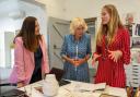 Founder Monica Vinader (left) shows Queen Camilla (centre) her jewellery during a visit to Monica Vinader's design studio