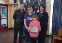 With Ava Buck, 9, are, from left, Swanton Morley VC Primary School headteacher Mr Richardson, mum erica Buck and and Mrs Wilton.