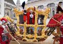 Nicholas Lyons waves from his state coach at the Lord mayor's Show in 2022