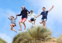 The image, released alongside a message wishing The Prince of Wales a happy 42nd birthday, shows the future king jumping alongside his three children