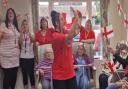 Chloe Lawlor leads a singing celebration to Leon Mallet's 'Let's Be Avin You' at a north Norfolk care home.