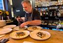 Chef Elliot Ketley preparing dishes at the Hello Sailor Supper Club