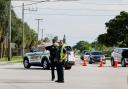 Police officers direct traffic near Trump International Golf Club after the apparent assassination attempt of Republican presidential nominee Donald Trump in West Palm Beach, Florida (Terry Renna/AP)