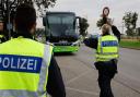 German police officers stop a bus at the border between Germany and France in Kehl, Germany (Jean-Francois Badias/AP)