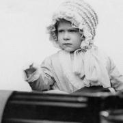 Princess Elizabeth - daughter of the Duke and Duchess of York (later King and Queen of England) - waves from the carriage as she drives in London in 1928.