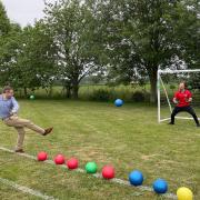 Duncan Baker, MP for North Norfolk, taking part in a head-to-head with Hindringham head Tom Snowdon at beat the goalie at Hindringham Primary School as the finale for her 60 events for 60 years