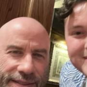 Jamie Salter with film star John Travolta, who dined at the Romany Rye, the Wetherspoon in Dereham, Norfolk.