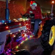 David and Phoebe Vardigans, along with Nigel Curson took to the streets in their festively decorated tractors for the third time this week to hand out cones of sweets to children across Fakenham