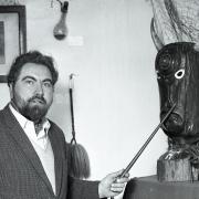 Mr Howard with the carved head of the god Atho, left to him by an old Romany woman.