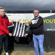 Todd Cantwell and Andrew Wright, vice-chair of Dereham Town Youth FC, with the kit donated from 4Sports