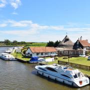 Acle Bridge Inn, Acle Bridge.  The pub viewed from the bridge next to the River Bure.  Credit: James Bass