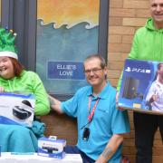 Elaine and Nick Loades present Steve Nicholls, play specialist at the Norfolk and Norwich University Hospitals NHS Foundation Trust, with donations raised through Ellie's Love, a charity set up in memory of their daughter.  Picture: N&NUH