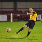 A Fakenham Town player shoots at goal during a match at Clipbush Park. Picture: IAN BURT