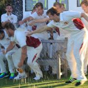 The alcohol flows as Fakenham celebrate winning the title. Picture: RONNIE HEYHOE