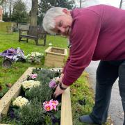 Weasenham parish councillor Jacqueline Hargreaves has rolled her sleeves up to plant up the new planters