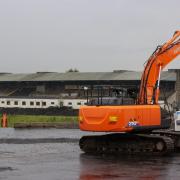 Contractors with excavators have begun clearing the concrete seating terraces at GAA stadium in Belfast (PA)