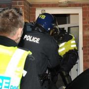 Police raid a property as part of a modern slavery investigation