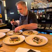 Chef Elliot Ketley preparing dishes at the Hello Sailor Supper Club