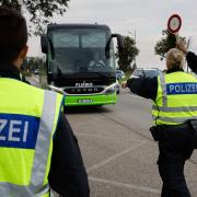 German police officers stop a bus at the border between Germany and France in Kehl, Germany (Jean-Francois Badias/AP)